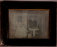 Thumbnail preview of A couple sitting outside a house in the garde…