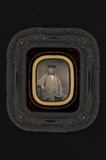 Thumbnail preview of portrait of a man with a cap, sitting in a ch…