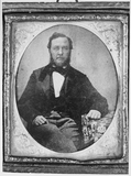Thumbnail preview van portrait of a seated man with sideburns, a ta…
