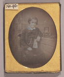 Thumbnail preview of Three quarter length portrait of a boy, seate…