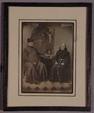 Thumbnail af Two men in religious garb sit on either side …