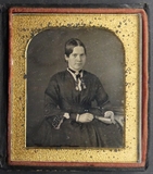 Prévisualisation de portrait of a woman, sitting near table with … imagettes
