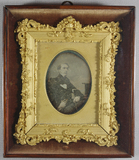 Stručný náhled Framed photograph of a seated man, three quar…