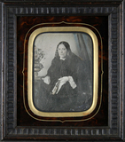 Thumbnail preview of Three-quarter portrait of a seated middle-age…
