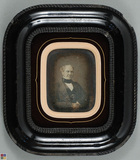 Thumbnail preview van Half-lenght portrait of eldery seated man hol…