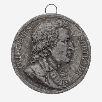 medaille, munt van klei met daar op de afbeelding van Frediricus Schiller